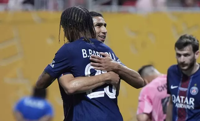 Paris Saint-Germain's Achraf Hakimi celebrates his goal with Paris Saint-Germain's Bradley Barcola during the Club World Cup round of 16 soccer match between PSG and Inter Miami in Atlanta, Sunday, June 29, 2025. (AP Photo/Mike Stewart)