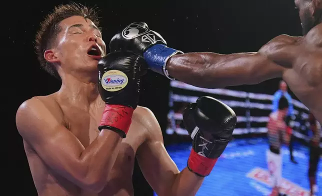 Cuba's Andy Cruz, right, punches Japan's Hironori Mishiro during the fourth round of a lightweight boxing match Saturday, June 14, 2025, in New York. (AP Photo/Frank Franklin II)