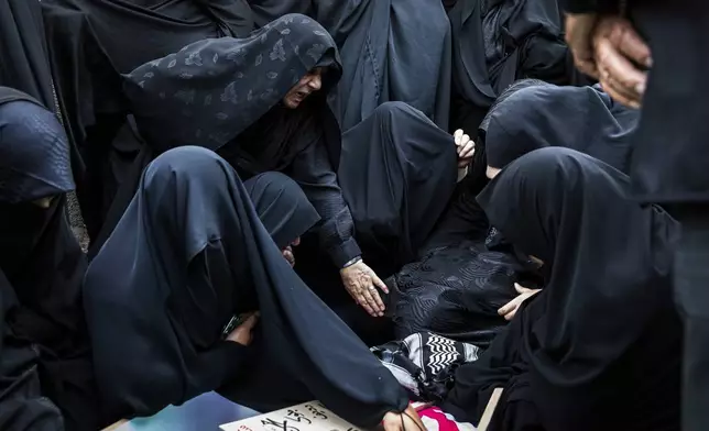 Women mourn over the body of Mohammadi Javad Naseri, who was reportedly killed in Israeli strikes in the northwestern Iranian city of Tabriz, Monday, June 16, 2025. (AP Photo/Matin Hashemi)