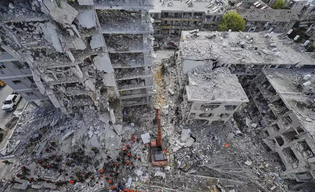 Israeli soldiers search through the rubble of residential buildings destroyed by an Iranian missile strike in Bat Yam, central Israel, on Sunday, June 15, 2025. (AP Photo/Baz Ratner)