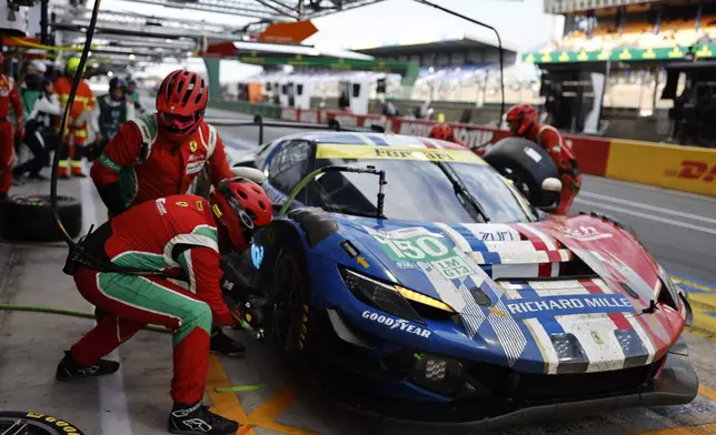 The car number 150 RICHARD MILLE AF CORSE a Ferrari 296 LMGT3, makes a pit stop during the 24-hour Le Mans endurance race, Sunday June 15, 2025 in Le Mans, western France. (AP Photo/Jeremias Gonzalez)