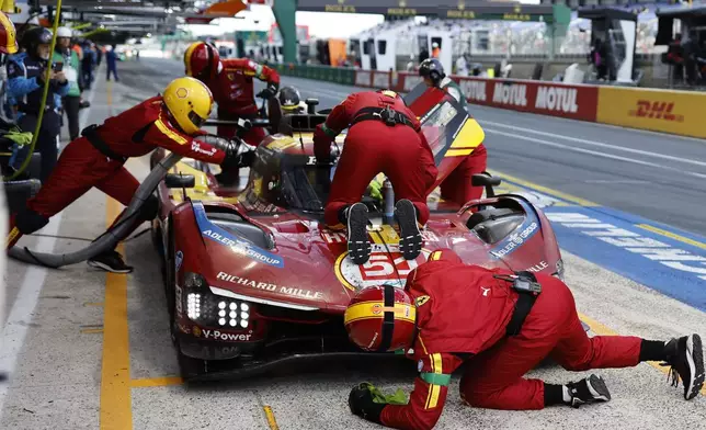 The car number 51 Ferrari AF Corse car a Ferrari 499P with Alessandro Pier Guidi of Italy, James Calado of Great Britain and Antonio Giovinazzi of Italy, makes a pit stop during the 24-hour Le Mans endurance race, Sunday June 15, 2025 in Le Mans, western France. (AP Photo/Jeremias Gonzalez)