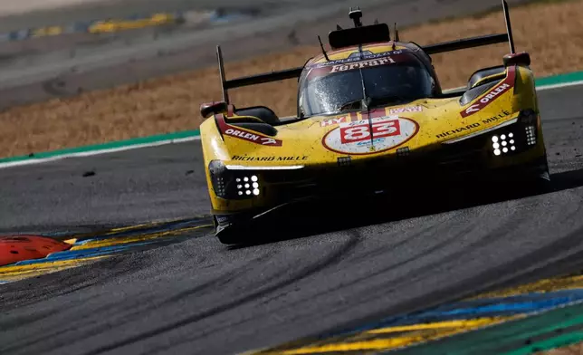 AF Corse car (starting no. 83) a Ferrari 499P with Robert Kubica of Poland, Yifei Ye of China and Phil Hanson of Great Britain takes a curve during the 24-hour Le Mans endurance race, Sunday June 15, 2025 in Le Mans, western France. (AP Photo/Jeremias Gonzalez)