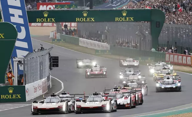 Cars race during the start of the 24-hour Le Mans endurance race, Saturday, June 14, 2025 in Le Mans, western France. (AP Photo/Jeremias Gonzalez)