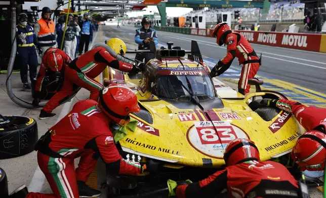 The cars number 83 AF Corse cara Ferrari 499P with Robert Kubica of Poland, Yifei Ye of China and Phil Hanson of Great Britain makes a pit stop during the 24-hour Le Mans endurance race, Sunday June 15, 2025 in Le Mans, western France. (AP Photo/Jeremias Gonzalez)