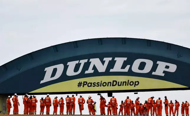 Technical staff wait for the start of the 24-hour Le Mans endurance auto race, in Le Mans, western France, Saturday, June 14, 2025 in Le Mans, western France. (AP Photo/Jeremias Gonzalez)