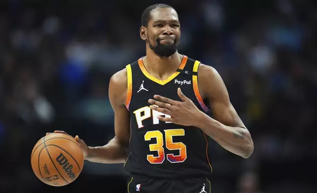 FILE - Phoenix Suns forward Kevin Durant gestures during the second half of an NBA basketball game on March 9, 2025, in Dallas. (AP Photo/Julio Cortez, File)
