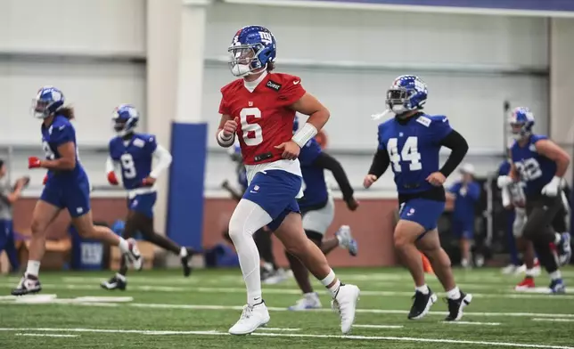 New York Giants quarterback Jaxson Dart warms up during an NFL football practice, Wednesday, June 18, 2025, in East Rutherford, N.J. (AP Photo/Frank Franklin II)