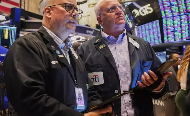 Traders Jeffrey Vazquez, left, and Thomas Ferrigno work on the floor of the New York Stock Exchange, Thursday, June 5, 2025. (AP Photo/Richard Drew)