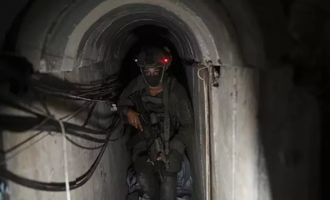 An Israeli soldier walks in a tunnel beneath the European Hospital in Khan Younis, southern Gaza, where the military claims Hamas militants had been operating, Sunday, June 8, 2025. (AP Photo/Ohad Zwigenberg)