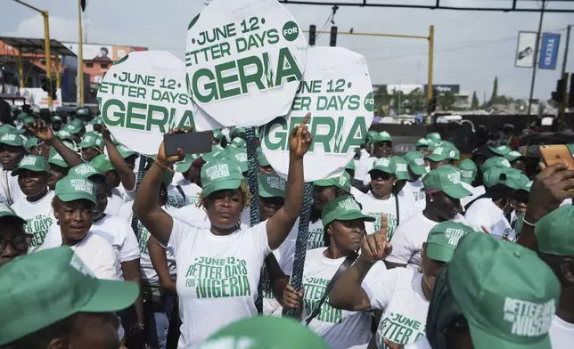 People dance to celebrate Democracy day on the streets of Lagos, Nigeria, Thursday, June 12, 2025. (AP Photo/Sunday Alamba)