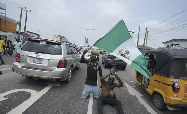 People attend anti-government protests on streets of Lagos, Nigeria, Thursday, June 12, 2025. (AP Photo/Sunday Alamba)