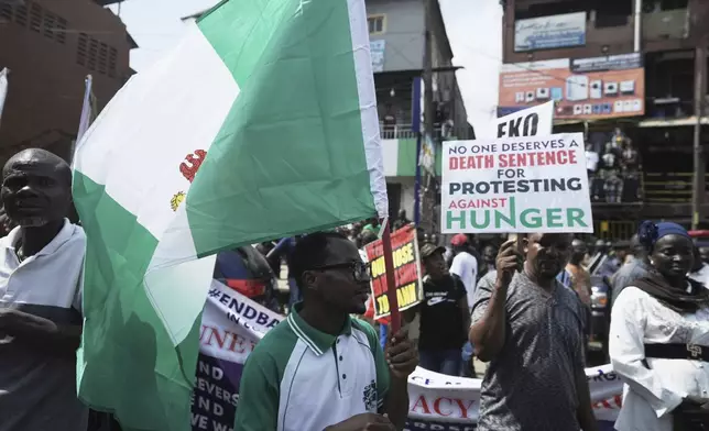 People attend anti-government protests on streets of Lagos, Nigeria, Thursday, June 12, 2025. (AP Photo/Sunday Alamba)