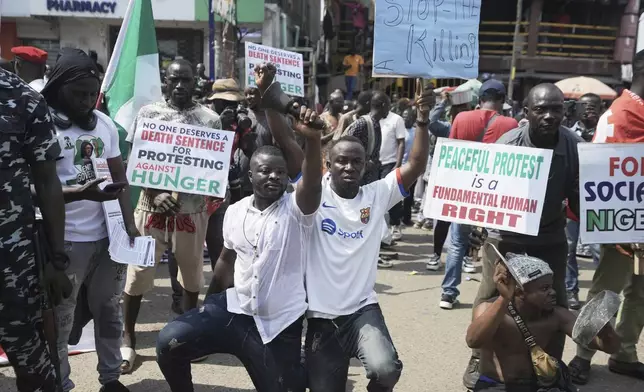 People gather for anti-government protests on the streets of Lagos Nigeria, Thursday, June 12, 2025. (AP Photo/Sunday Alamba)