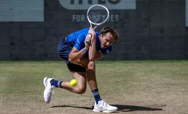 Russia's Daniil Medvedev returns the ball to Germany's Alexander Zverev, during their men's singles semifinal, at the Halle tennis tournament, Germany, Saturday, June 21, 2025. (David Inderlied/dpa via AP)