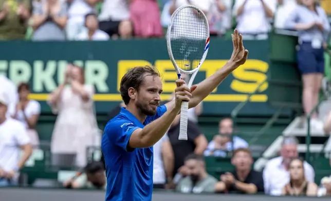 Russia's Daniil Medvedev celebrates beating Germany's Alexander Zverev, during their men's singles semifinal, at the Halle tennis tournament, Germany, Saturday, June 21, 2025. (David Inderlied/dpa via AP)