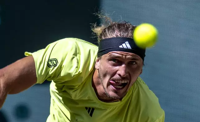 Germany's Alexander Zverev serves a ball to Russia's Daniil Medvedev during their men's singles semifinal, at the Halle tennis tournament, Germany, Saturday, June 21, 2025. (David Inderlied/dpa via AP)