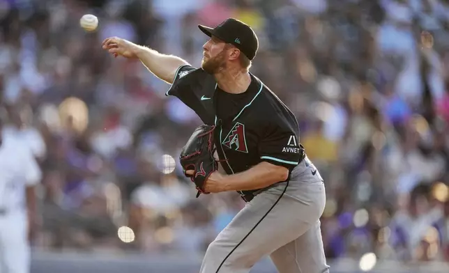 Arizona Diamondbacks starting pitcher Merrill Kelly works against the Colorado Rockies in the first inning of a baseball game Saturday, June 21, 2025, in Denver. (AP Photo/David Zalubowski)
