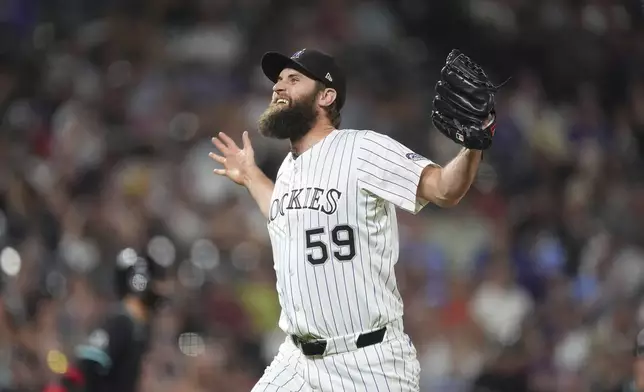 Colorado Rockies relief pitcher Jake Bird reacts after striking out Arizona Diamondbacks' Tim Tawa to end the top of the eighth inning of a baseball game Saturday, June 21, 2025, in Denver. (AP Photo/David Zalubowski)