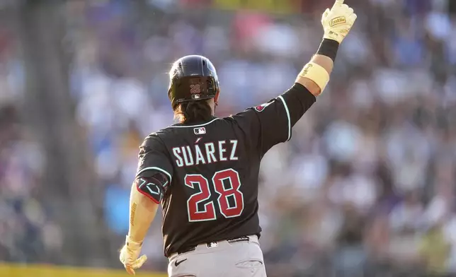 Arizona Diamondbacks' Eugenio Suárez gestures to the bullpen as he circles the bases after hitting a solo home run off Colorado Rockies starting pitcher Carson Palmquist in the third inning of a baseball game Saturday, June 21, 2025, in Denver. (AP Photo/David Zalubowski)