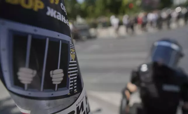 A Serbian gendarmerie officer guards an intersection after the removal of a street blockade that was set up as part of a protest over a spate of arrests of anti-government protesters after a massive rally demanding an early parliamentary election in Belgrade, Serbia, Monday, June 30, 2025. (AP Photo/Darko Vojinovic)