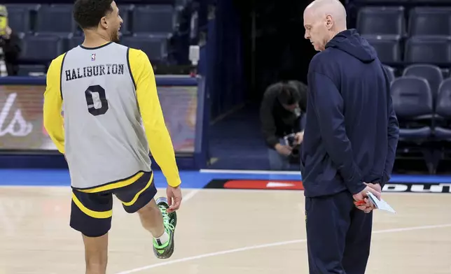 Indiana Pacer coach Rick Carlisle, right, watches guard Tyrese Haliburton (0) stretch during a practice, Wednesday, June 4, 2025, ahead of Game 1 of the NBA Finals basketball series against the Oklahoma City Thunder in Oklahoma City. (AP Photo/Nate Billings)