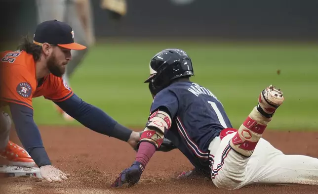 Houston Astros second baseman Brendan Rodgers, left, tags out Cleveland Guardians' Angel Martinez (1) at second base in the first inning of a baseball game in Cleveland, Friday, June 6, 2025. (AP Photo/Sue Ogrocki)