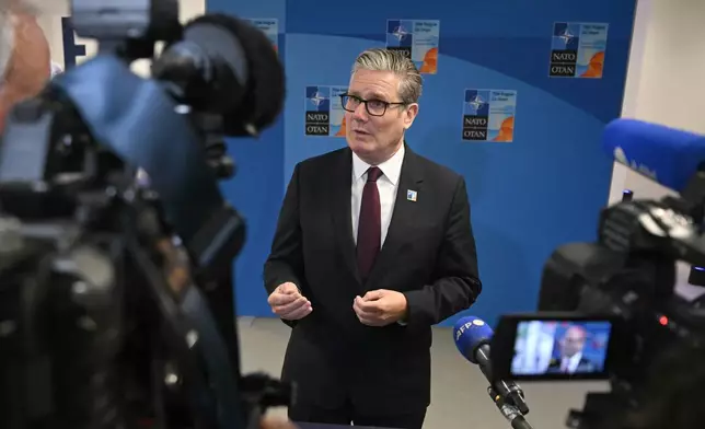 Britain's Prime Minister Keir Starmer speaks to the media as he arrives for the NATO summit of heads of state and government in The Hague Wednesday, June 25, 2025. (Ben Stansall/Pool Photo via AP)