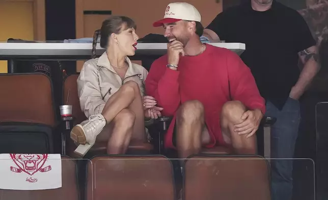 Singer Taylor Swift, left, and Kansas City Chiefs football player Travis Kelce, front right, take in the third period in Game 4 of the NHL hockey Stanley Cup Final between the Edmonton Oilers and the Florida Panthers in Sunrise, Fla., Thursday, June 12, 2025. (Nathan Denette/The Canadian Press via AP)