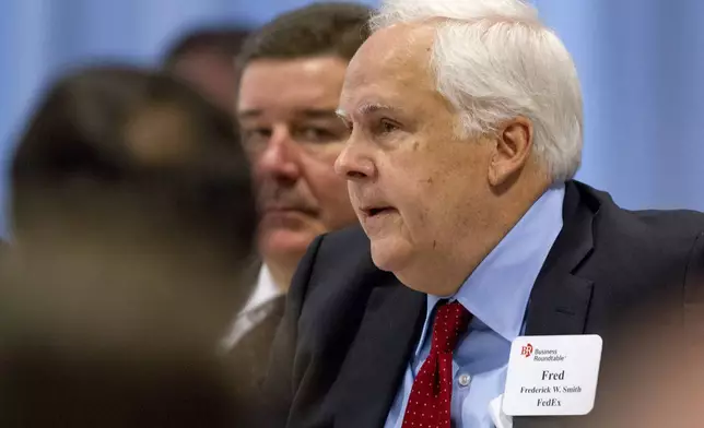 FILE - FedEx founder and CEO Fred Smith asks a question of President Barack Obama during the president's meeting with leading CEOs to discuss ways to promote the economy and create jobs during his last two years in office, Wednesday, Dec. 3, 2014, at the Business Roundtable Headquarters in Washington. (AP Photo/Jacquelyn Martin, File)