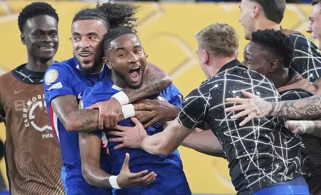 Chelsea's Christopher Nkunku is congratulated after scoring his teams second goal during the Club World Cup round of 16 soccer match between Benfica and Chelsea in Charlotte, N.C., Saturday, June 28, 2025. (AP Photo/Chris Carlson)