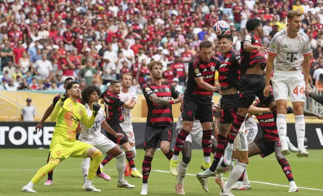 Flamengo's Erick Pulgar, center, heads a ball to scores a own goal during the Club World Cup round of 16 soccer match between CR Flamengo and Bayern Munich in Miami Gardens, Fla., Sunday, June 29, 2025. (AP Photo/Rebecca Blackwell)