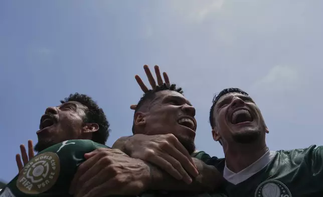 Palmeiras' Paulinho, center, celebrates with teammates after scoring the opening goal during the Club World Cup round of 16 soccer match between Palmeiras and Botafogo in Philadelphia, Saturday, June 28, 2025. (AP Photo/Matt Slocum)