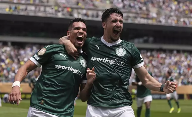 Palmeiras' Paulinho, left, celebrates with Joaquin Piquerezd after scoring the opening goal during the Club World Cup round of 16 soccer match between Palmeiras and Botafogo in Philadelphia, Saturday, June 28, 2025. (AP Photo/Matt Slocum)