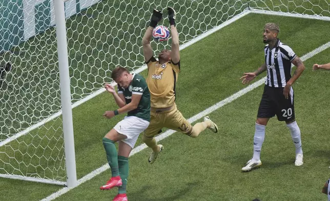 Botafogo's goalkeeper John makes a save challenged by Palmeiras' Bruno Fuchs during the Club World Cup round of 16 soccer match between Palmeiras and Botafogo in Philadelphia, Saturday, June 28, 2025. (AP Photo/Chris Szagola)