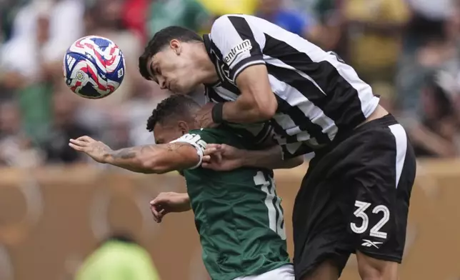 Botafogo's Jair Cunha (32) and Palmeiras' Paulinho (10) battle for a head ball during the Club World Cup round of 16 soccer match between Palmeiras and Botafogo in Philadelphia, Saturday, June 28, 2025. (AP Photo/Matt Rourke)