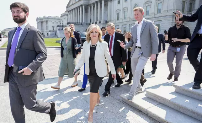 Sen. Marsha Blackburn, R-Tenn., walks to board a bus to the White House with other Senate Republicans for a meeting with President Donald Trump on his spending and tax bill, Wednesday, June 4, 2025, outside the U.S. Capitol in Washington. (AP Photo/Julia Demaree Nikhinson)