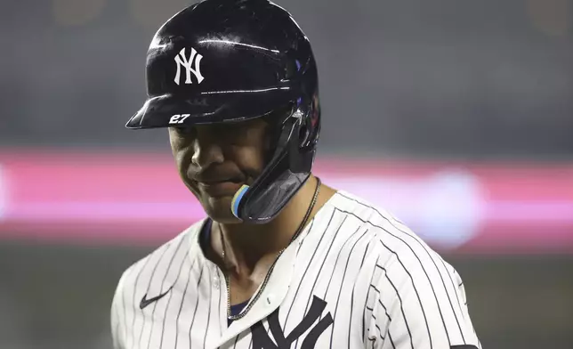 New York Yankees' Giancarlo Stanton walks to the dugout after flying out to Los Angeles Angels shortstop Zach Neto during the ninth inning of a baseball game Tuesday, June 17, 2025, in New York. (AP Photo/Pamela Smith)