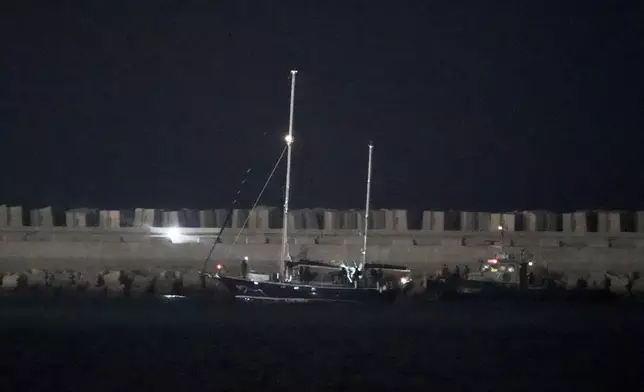 The Gaza-bound aid boat, Madleen, under escort of Israeli naval forces enters to Ashdod Port in southern Israel after being seized by Israeli forces, Monday, June 9, 2025. (AP Photo/Leo Correa)