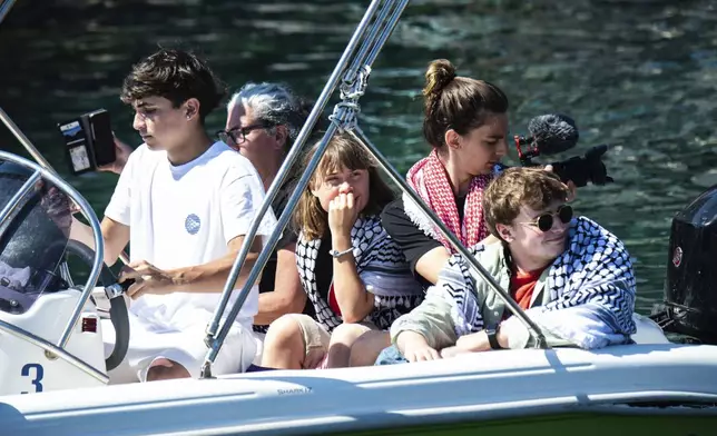 Climate activist Greta Thunberg, center, waits to board the Madleen boat, before setting sail for Gaza along with activists of the Freedom Flotilla Coalition, departing from the Sicilian port of Catania, Italy, Sunday, June 1, 2025. (AP Photo/Salvatore Cavalli)