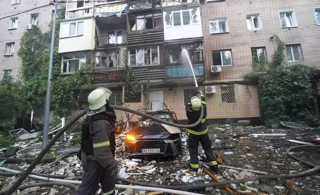Firefighters tackle a blaze after a Russian attack that hit a residential building in Kharkiv, Ukraine, Saturday, June 7, 2025. (AP Photo/Andrii Marienko)