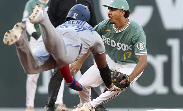 Boston Red Sox second baseman David Hamilton, right, waits for the throw as the Toronto Blue Jays' Vladimir Guerrero Jr. dives into the base safely with a steal of second in the first inning of a baseball game Friday, June 27, 2025, in Boston. (AP/Photo/Jim Davis)