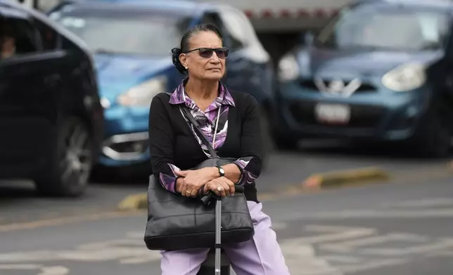 Socorro Rivera sits at a square where Lenia Batres, who is running for election for the Mexican Supreme Court, delivers a speech at her closing campaign rally in Mexico City, Wednesday, May 28, 2025. (AP Photo/Fernando Llano)