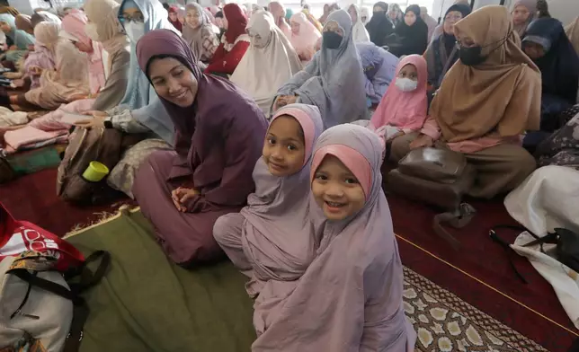 Muslims wait to pray during the Eid al-Adha prayers at Taipei Grand Mosque in Taipei, Taiwan, Friday, June 6, 2025. (AP Photo/Chiang Ying-ying)