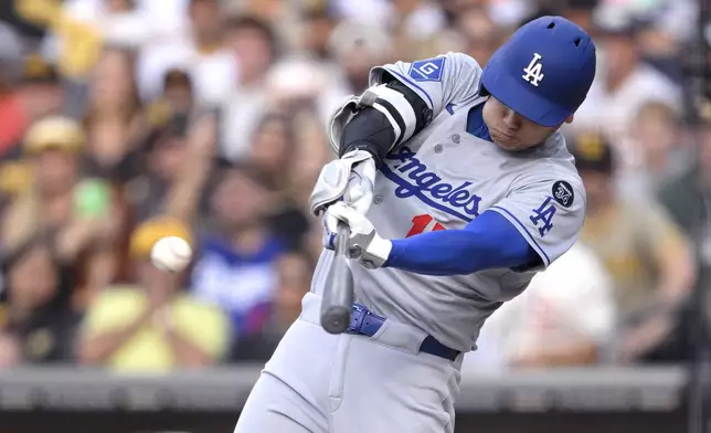 Los Angeles Dodgers' Shohei Ohtani (17) hits a double against the San Diego Padres during the first inning of a baseball game Monday, June 9, 2025, in San Diego. (AP Photo/Orlando Ramirez)