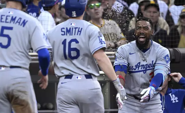Los Angeles Dodgers' Will Smith (16) has sunflower seeds tossed at him by Teoscar Hernandez, right, after hitting a two-run home run against the San Diego Padres during the third inning of a baseball game Monday, June 9, 2025, in San Diego. (AP Photo/Orlando Ramirez)