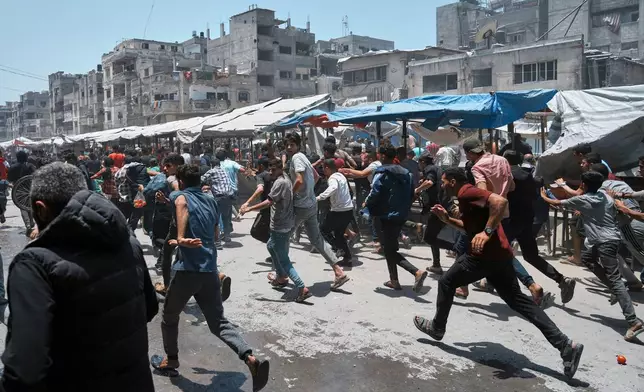 Palestinians run following an Israeli strike in Gaza City, Sunday, June 1, 2025. (AP Photo/Jehad Alshrafi)