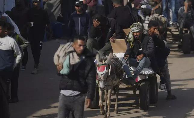 Palestinians carry boxes and bags containing food and humanitarian aid packages delivered by the Gaza Humanitarian Foundation, a U.S.-backed organization approved by Israel, in Khan Younis, southern Gaza Strip, Sunday, June 1, 2025. (AP Photo/Abdel Kareem Hana)