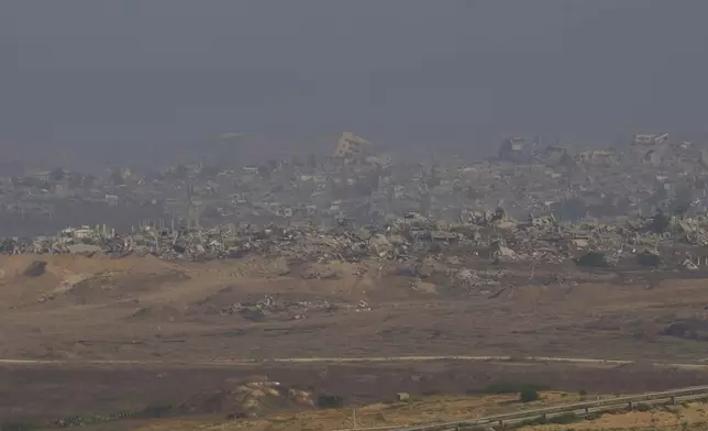 Destroyed buildings in the Gaza Strip are seen from southern Israel, Sunday, June 1, 2025. (AP Photo/Ohad Zwigenberg)