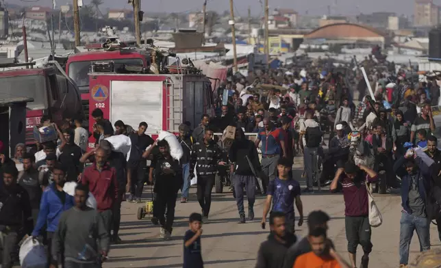 Palestinians carry boxes and bags containing food and humanitarian aid packages delivered by the Gaza Humanitarian Foundation, a U.S.-backed organization approved by Israel, in Khan Younis, southern Gaza Strip, Sunday, June 1, 2025. (AP Photo/Abdel Kareem Hana)